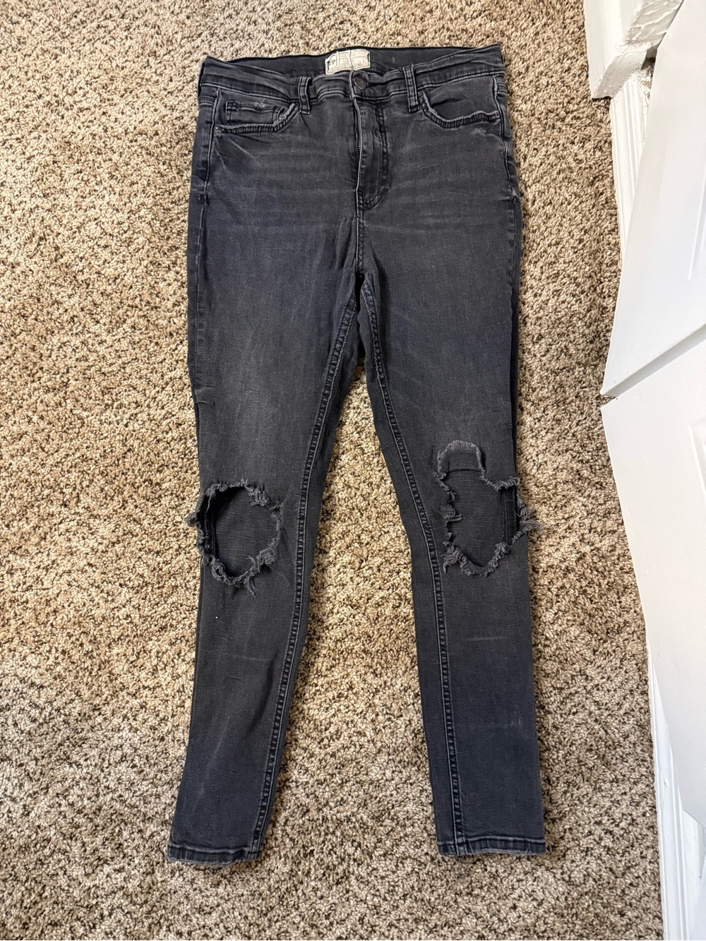 Free People black skinny jeans with ripped knees